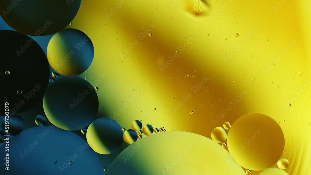 Aufkleber real close up oil bubbles in water rotation with color gradient abstract mixing background.