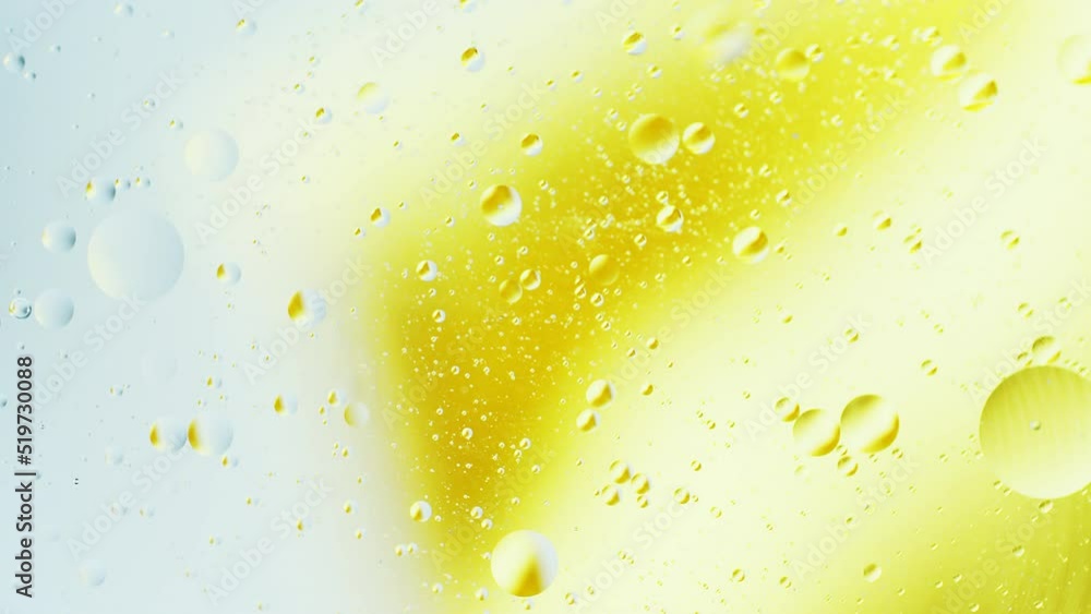 Aufkleber real close up oil bubbles in water rotation with color gradient abstract mixing background.