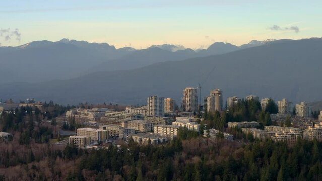 Comprehensive College And Main Campus Of Simon Fraser University Over The Greenery Of Burnaby Highland In Canada. Wide Drone Shot