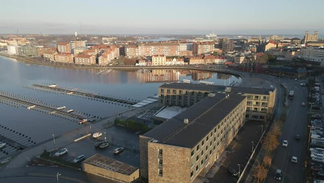 Aerial footage on a cold winter day in Karlskrona, Sweden with a view of the beautiful churches in the background, the city skyline and the boat docks in front of Scandic hotel.