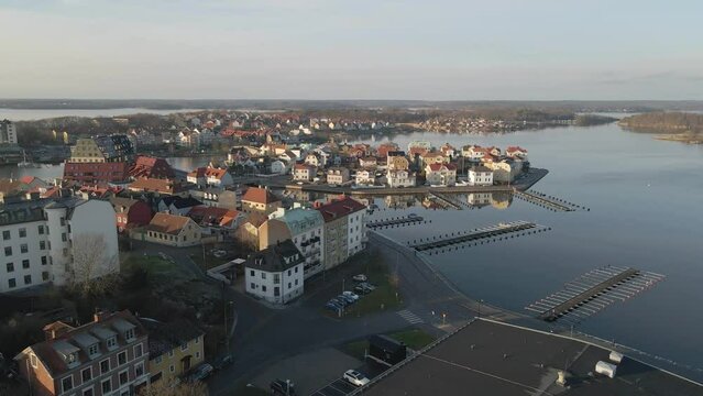 Aerial footage on a cold winter day in Karlskrona, Sweden with a view of some empty docks and the beautiful island Bjorkholmen and Ekholmen next to it.