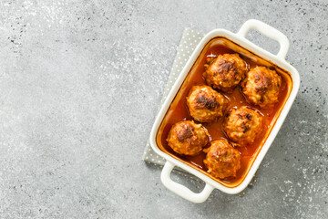 Oven baked Italian meatballs in baking dish. Top view, copy space, flat lay.