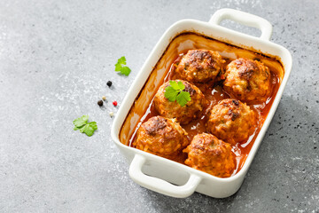 Meatballs and gravy in baking dish. Top view, copy space, flat lay.