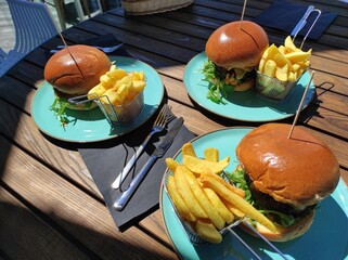 Burger and fries. Food in restaurant on a dinner. Hamburger with beef and lettuce on a plate. Homemade  and healthy food for lunch.