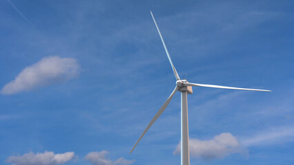 Wind mills rotating by the force of the wind and generating renewable energy in a green ecologic way to the planet	