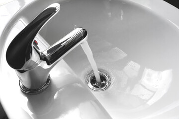 Faucet with Running Fresh Water in a Sink - 519734446