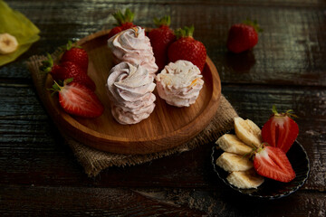 Assorted natural sugar free marshmallows with banana and strawberry taste in low key. Healthy sweets, natural dessert.