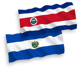 National vector fabric wave flags of Republic of Costa Rica and Republic of El Salvador isolated on white background. 1 to 2 proportion.