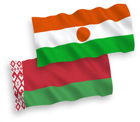 National vector fabric wave flags of Republic of the Niger and Belarus isolated on white background. 1 to 2 proportion.