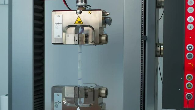 Polymer thread sample tape for plastic sack bags is tested for strength in laboratory