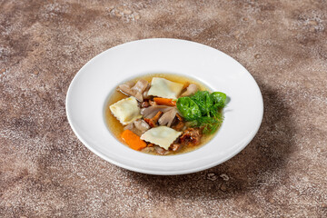 Mushroom soup with rabbit ravioli