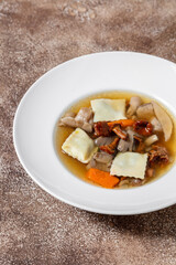 Mushroom soup with rabbit ravioli