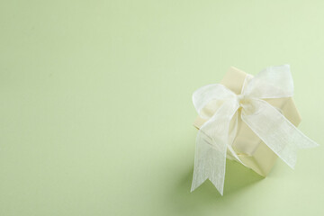 Gift box on green background, space for text