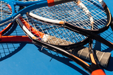 broken tennis rackets blue tennis court