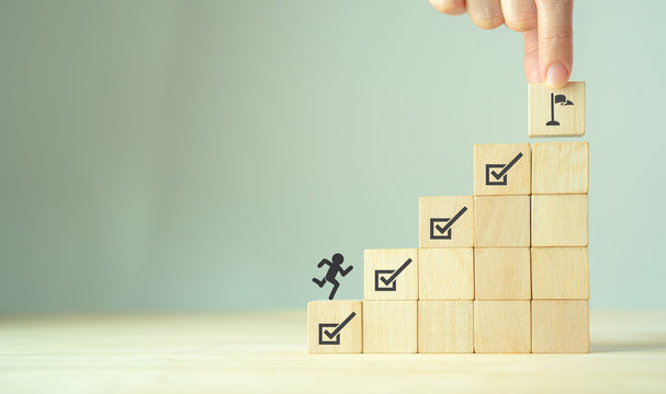 Corporate regulatory and compliance. Goals achievement and business success. Project and goals tracking. Task completion. Managing project timeline. Wooden cubes with target achievement icon.