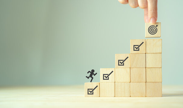 Corporate regulatory and compliance. Goals achievement and business success. Project and goals tracking. Task completion. Managing project timeline. Wooden cubes with target achievement icon.