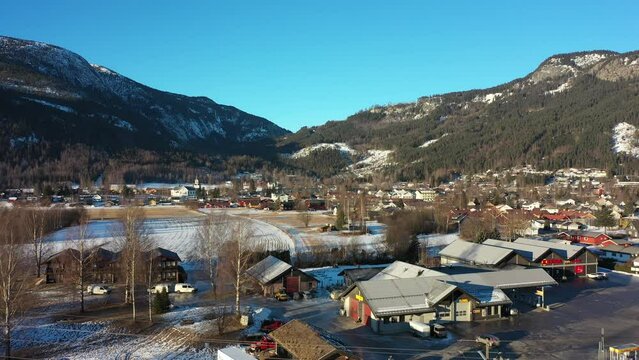 Nesbyen ascending sunrise aerial looking towards farmland and hills leading to Nesfjellet mouintain crossing and alpine center