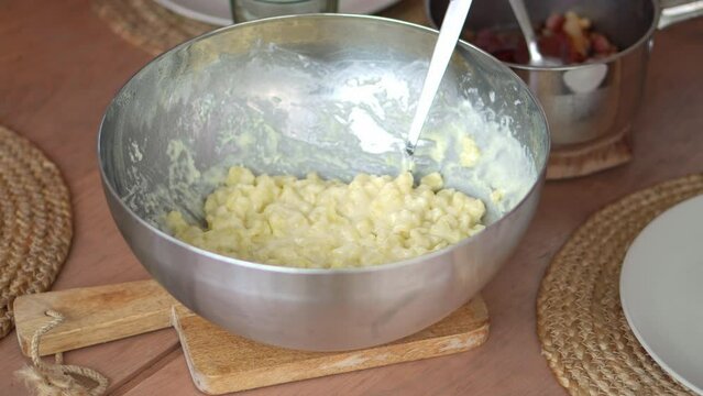 Boiled Potato Dough Lumps And Sheep Cheese Mixture In A Mixing Bowl. Bryndzove Halusky Dumplings. close up