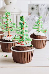 Obraz na płótnie Canvas Chocolate Christmas cupcake with colored sugar topping