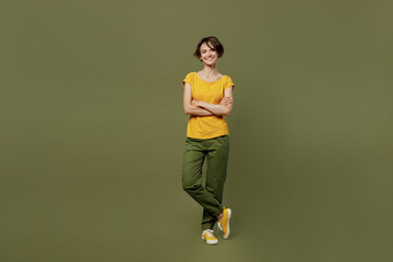 Full body young smiling confident happy woman she 20s wear yellow t-shirt look camera hold hands...