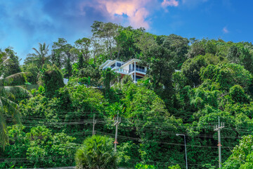 Villa Mansion in Phuket Mountains over looking Karon Beach lovely Skies Sunset over  Patong Pa Tong Beach in Phuket island Thailand. Lovely lush green mountains colourful skies