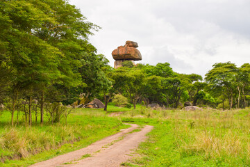 African landscape with a dirt road and natural balancing rocks, Zimbabwe.