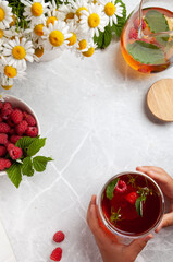 food frame on a light background with tea, berries and flowers. tea party concept, summer, summer kitchen, summer menu, summer breakfast, herbal tea