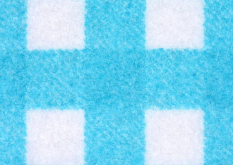 Macro shut of Clean sponge cloths with a checkered pattern texture background. Household cleaning cloth. Closeup of cleaning rag.