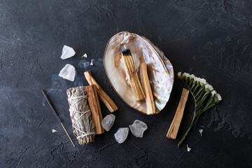 Palo Santo stick burning with aroma smoke, white sage, crystals for meditation esoteric ceremony....