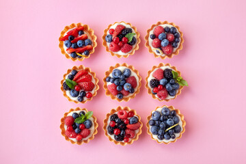 Set of different tartlets or cake with cream cheese, honey and summer berry. Pastry dessert top view. Flat lay.