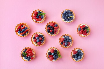 Set of different tartlets or cake with cream cheese, honey and summer berry. Pastry dessert top...