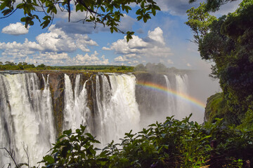 The iconic Victoria Falls, aka Mosi-Oa-Tunya waterfall, view from the Zimbabwe side with a rainbow.