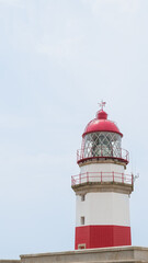 lighthouse on mountain with mountain background