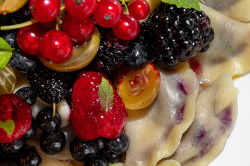 Dumplings with raspberries, kumquats, blackberries