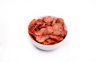 Salami chips, meat snacks in a bowl, isolated. Salami slices, close-up. Packshot photo for package design.