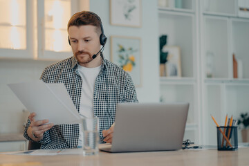 Young man analyzing information during an online call at home