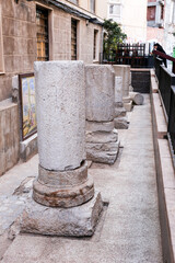 Remains of pillars of roman road on the street