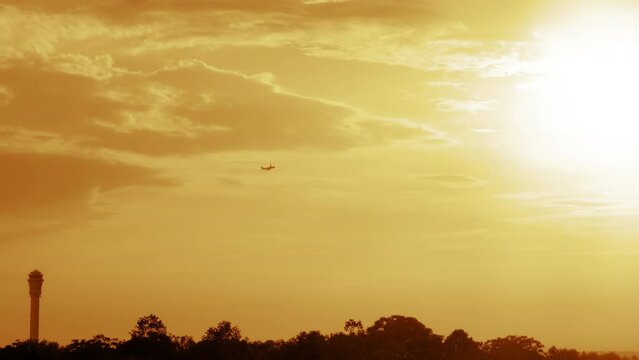 Plane Flies into the Sunset Sky