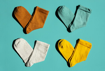 Some socks on turquoise background. Layout colourful socks.