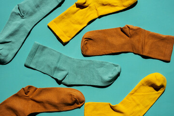 Some socks on turquoise background. Layout colourful socks.