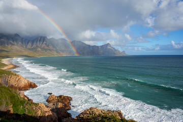 View with rainbow towards Rooi Els and Hanklip from Clarence Drive on the eastern side of False Bay. Cape Town, Western Cape, South Africa.