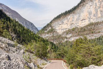 Mountain road through a valley in the Dolomites