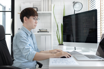 Professional development programmers are sit on a desk with work equipment such as: computer-laptop-tablet. for working in programming or writing code on  website,  HTML, javascript, Software.