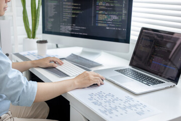 Professional development programmers are sit on a desk with work equipment such as: computer-laptop-tablet. for working in programming or writing code on  website,  HTML, javascript, Software.