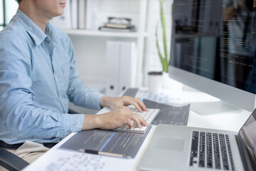 Professional development programmers are sit on a desk with work equipment such as: computer-laptop-tablet. for working in programming or writing code on  website,  HTML, javascript, Software.