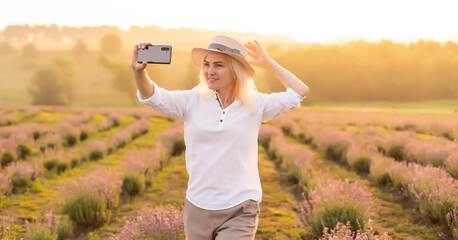 woman taking photo by phone in the lavender field