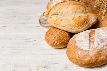 Homemade natural breads. Different kinds of fresh bread as background, perspective view with copy space