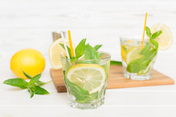 Mojito cocktail. Refreshing mojito cocktail with lime, lemon and mint in a tall glass with a stick