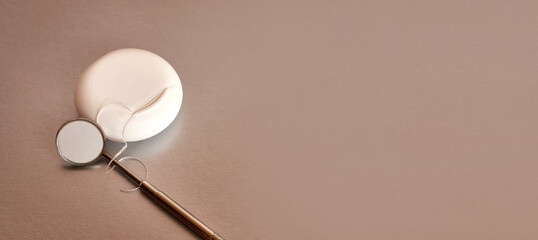 Dental mirror and dental floss on a gray background. Dental care.