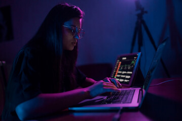 Fototapeta premium Attractive young woman working in home at night.
